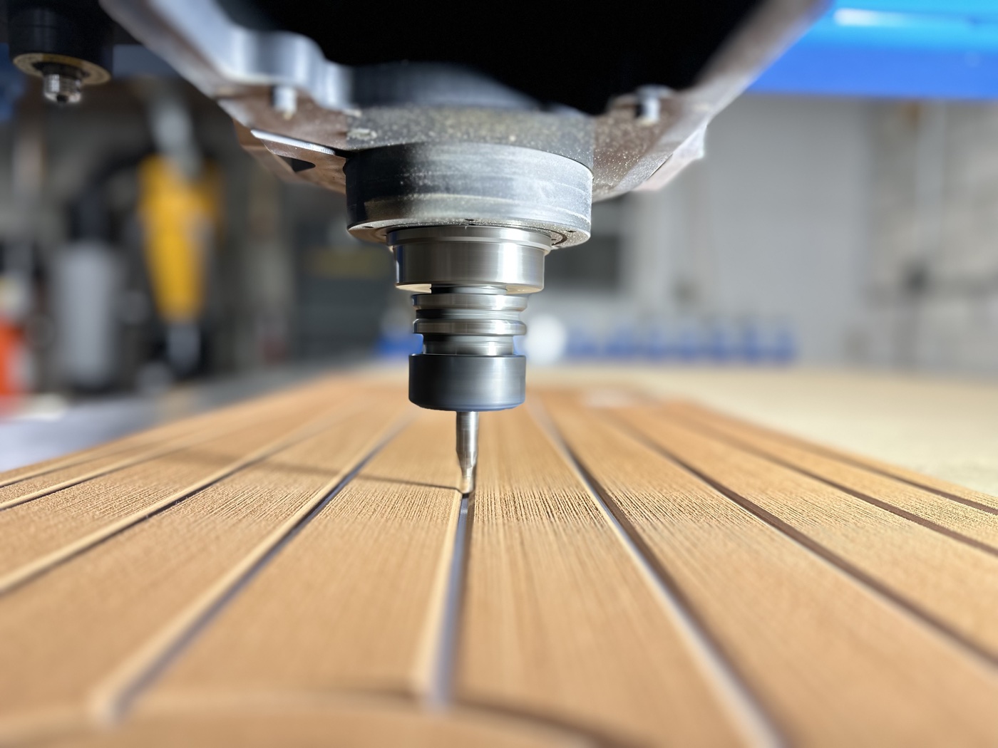 CNC router cutting plank grooves into an EVA foam sheet